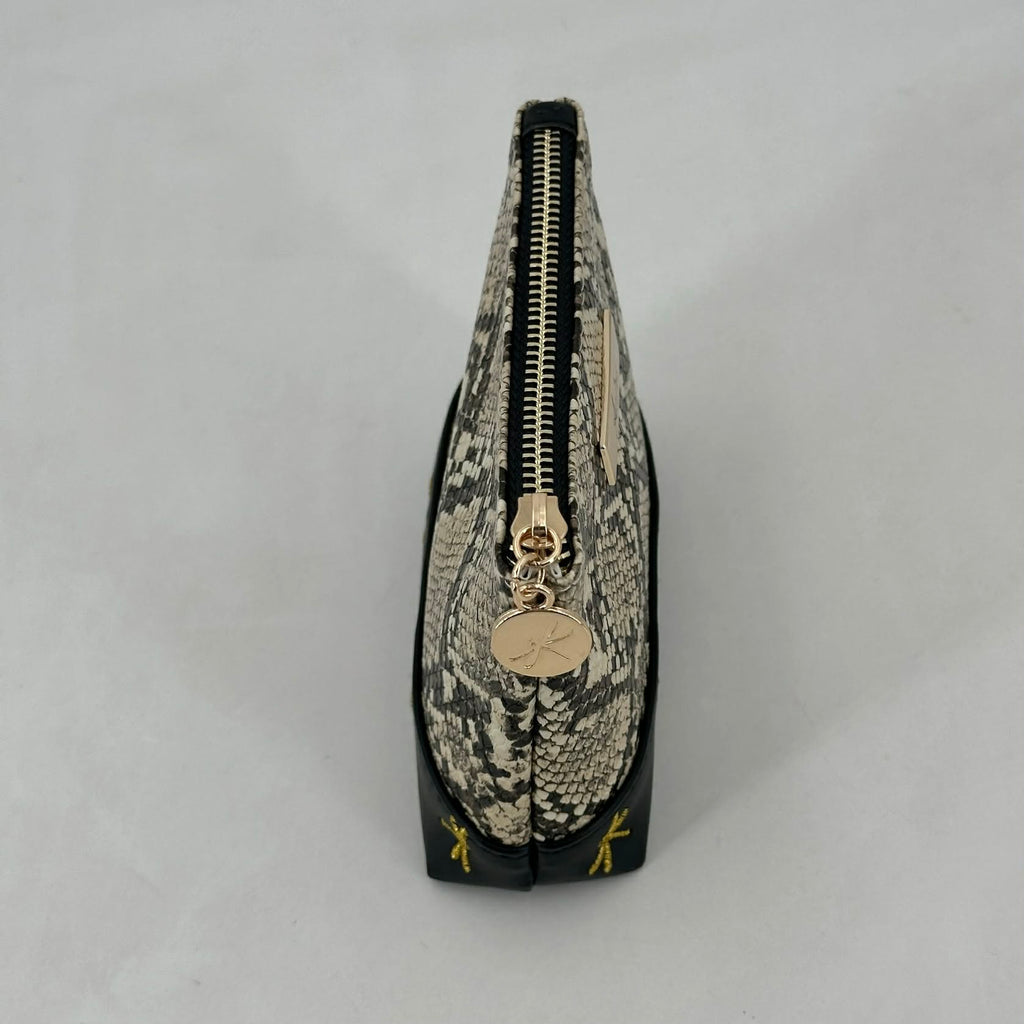 Snakeskin patterned pouch with gold zipper and logo on a light gray background